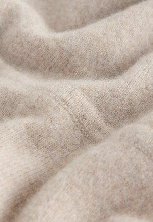 Jasno beżowa tkanina z miękką, teksturowaną powierzchnią; charakteryzuje się subtelnymi różnicami w kolorze oraz gładkim wykończeniem. Idealna do ciepłych ubrań.