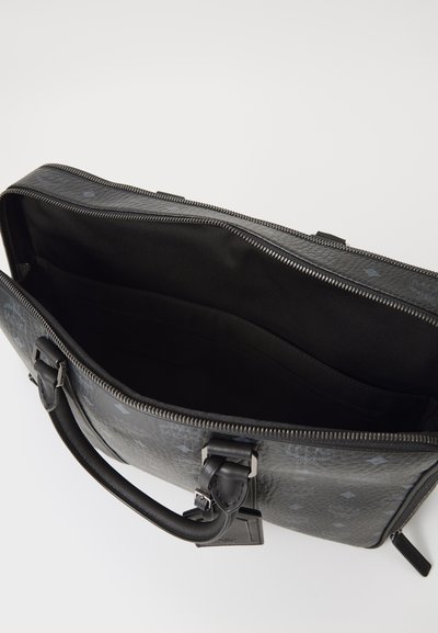 Black leather briefcase with a textured surface, zip closure, and inner pockets. Features a sturdy handle and subtle logo accents.