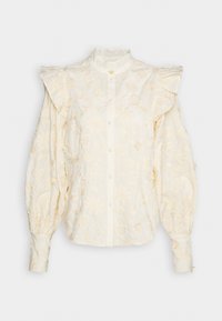Blusa bianca ricamata con maniche a palloncino, colletto alla mandarino e chiusura con bottoni frontale, decorata con motivi floreali e a cuore.