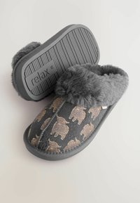 Grey slippers with a fluffy gray fur lining, featuring a repeated gold animal pattern on a dark base. Durable rubber sole with ridges.