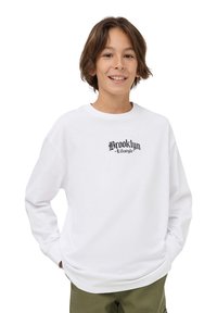 Felpa bianca con maniche lunghe, caratterizzata da una grafica nera "Brooklyn Lifestyle" sul petto. Tessuto di cotone morbido, vestibilità rilassata.