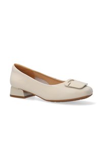 Beige patent leather ballet flats with a square toe and a decorative buckle detail. Low block heel and smooth texture.