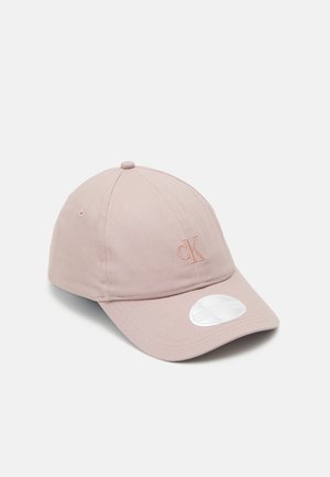 Light pink cotton cap with curved brim, small embroidered "cK" logo on front, and round white sticker on the brim.