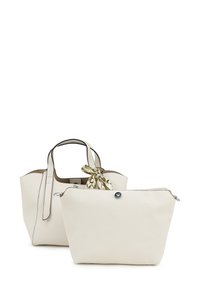 Two cream-colored bags: one is a textured tote with black accents and handles, the other is a smooth clutch with a zipper and decorative scarf.