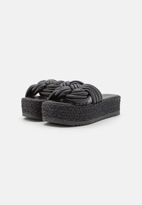 Sandales plateformes noires avec un design de bride tissée, en matériau en caoutchouc, et une semelle texturée en corde, avec un footbed lisse et un bout arrondi.