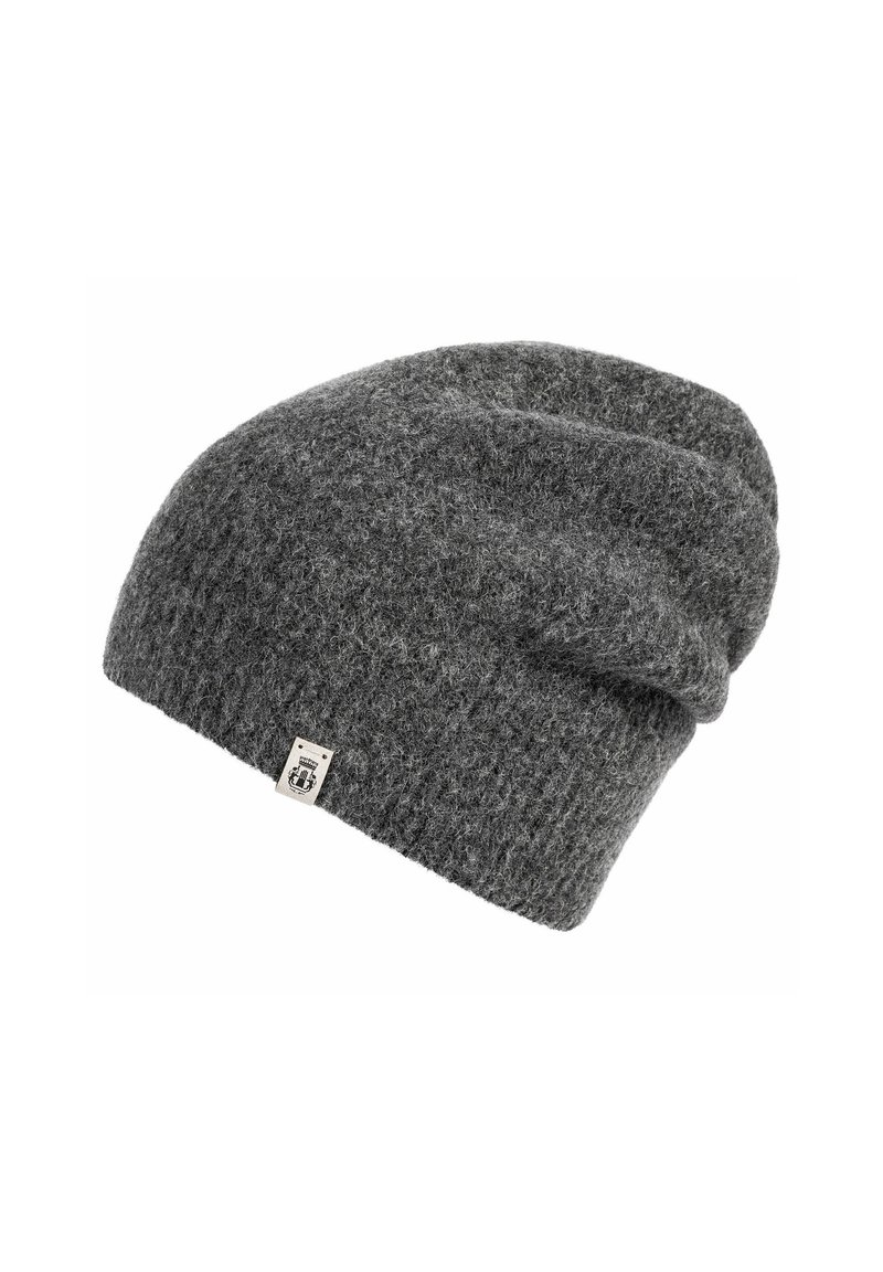 Dark gray knitted beanie with a small rectangular fabric tag on the edge, textured wool material, slouchy fit design.