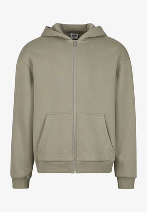 Jasnozielona bluza z kapturem wykonana z miękkiego materiału, z przednim zamkiem, dwiema kieszeniami, ściągaczami przy mankietach oraz regulowanym kapturem ze sznurkiem.