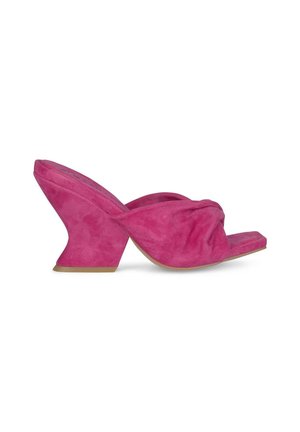 Pink suede heeled sandals featuring a unique curved wedge design and knotted upper section. Open-toe style with a flat sole.