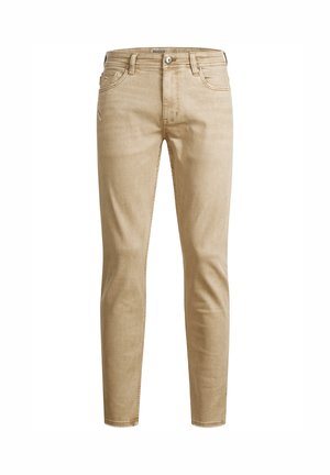 Beige Denim-Jeans mit Slim Fit, fünf Taschen, sichtbaren Nähten und Reißverschluss. Glatte Textur und moderne vertikale Linien.