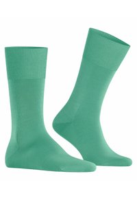 Grüne Baumwollsocken mit einem gerippten Bund, glatter Textur und typischer Sockenform, die für Komfort und den Alltag entwickelt wurden.
