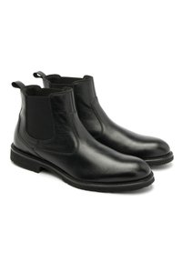 Czarne skórzane botki Chelsea z elastycznymi panelami bocznymi, zaokrąglonym noskiem i pętlami do zakładania. Gładka tekstura, niski obcas i trwała gumowa podeszwa.