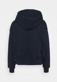 Marinblå hoodie med texturert tyg, som har en stor huva, sänkta axlar och ribbade ärmslut och nederkant. Bakåtblick visas.