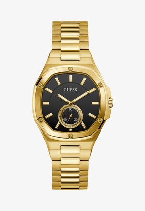Montre-bracelet en métal doré avec cadran noir, index dorés et un petit cadran des secondes à 6 heures, de la marque GUESS.
