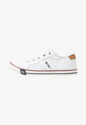 White canvas sneakers with a rubber sole, brown accent on heel, silver eyelets, red and blue stripe on sole, and brand detail on side.