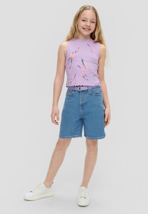 Fioletowy prążkowany crop top w kwiatowy wzór, z postrzępionym dołem, w połączeniu z niebieskimi szortami dżinsowymi i białymi trampkami. Prosty, casualowy strój.