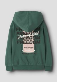 Sweat à capuche vert. Présente une impression graphique au dos, incluant "LIBERTÉ" et "BROOKLYN" dans diverses polices et couleurs.