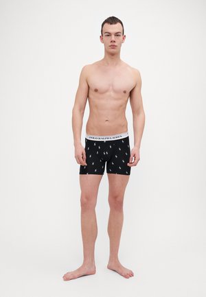 Schwarze Baumwoll-Boxershorts mit einem weißen Bund, der das Logo "POLO RALPH LAUREN" trägt, verziert mit einem sich wiederholenden Muster von Miniaturpferden.
