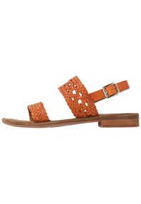 Womens' orange leather sandals with woven straps, adjustable ankle buckle, flat sole, and open toe design. Textured finish on straps.