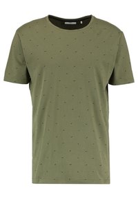 Olivenfarvet t-shirt lavet af blød bomuld. Kortærmet, rund halsudskæring, med et subtilt mønster af små, mørke pletter over det hele.