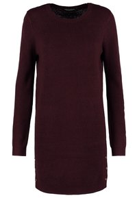 Burgundy knit sweater dress with long sleeves, round neckline, ribbed texture, and decorative button accents on the left side.