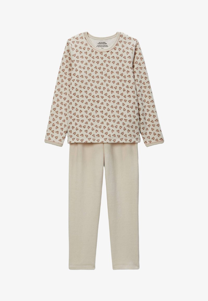 Ensemble de pyjama beige comprenant un haut à manches longues avec de petits motifs en forme de cœur éparpillés en marron, assorti à un pantalon de pyjama beige uni. Matière douce.