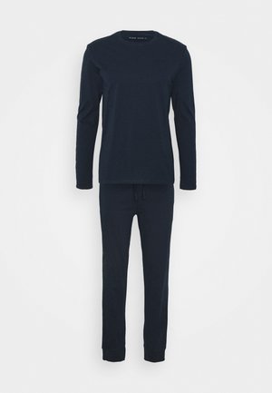Marineblå langærmet bluse og matchende bukser lavet af blød bomuldsblanding. Blusen har en rund hals; bukserne har en elastisk talje og manchetter.