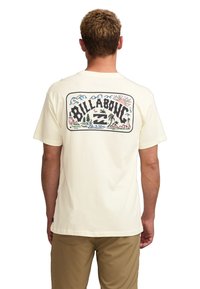 Cream-colored cotton t-shirt with a graphic depicting trees, water, and mountains on the back. Short sleeves, relaxed fit.