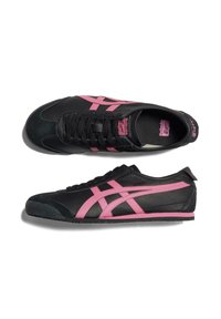 Black sneakers with pink accents, featuring a smooth leather upper, rounded toe, lace-up front, and a textured rubber sole.