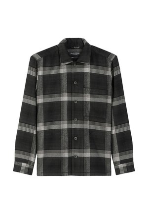 Camicia a scacchi bianca e nera con bottoni sul davanti, maniche lunghe e una tasca sul petto. Realizzata in tessuto testurizzato con colletto.