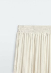 Pleated cream skirt with an elastic waistband, made of lightweight fabric. Features vertical lines and soft texture.