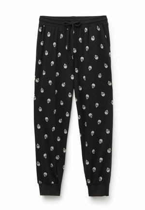 Zwarte joggingsbroek met een trekkoord in de taille, versierd met een herhalend patroon van kleine grijze schedels op de stof. Boorden bij de enkels.