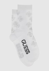 Hvide sokker med sølv rhinestone logo mønster, ribbet manchet og sort "GUESS" tekst på sålen. Glat tekstur og ankellængde.