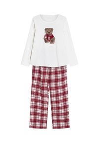Biała bluzka z długim rękawem z brązowym wzorem misia teddy. Czerwono-białe bawełniane spodnie do piżamy w kratę z elastycznym pasem.