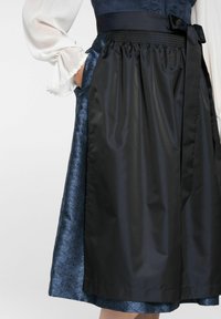 Black satin apron with a smooth texture over a blue floral patterned fabric; features a gathered waist and a ribbon tie.