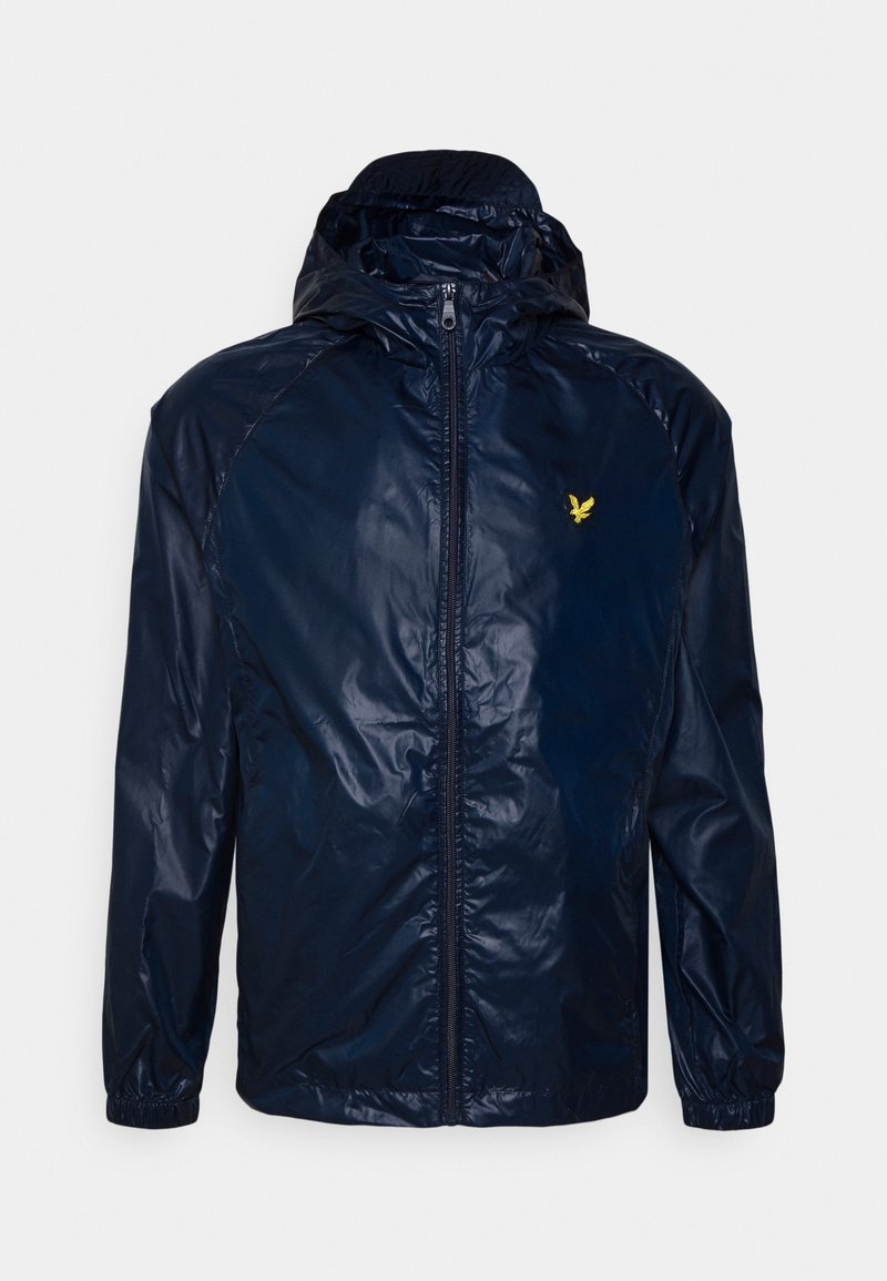 Navy blue waterproof jacket with a zip front, hood, and elastic cuffs. Features a small yellow logo on the chest. Smooth, shiny texture.