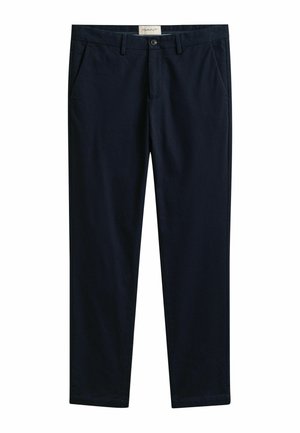Donkerblauwe broek met rechte pijpen, steekzakken aan de zijkant, riemlussen, knoopsluiting en een GANT-label aan de binnenzijde van de tailleband.