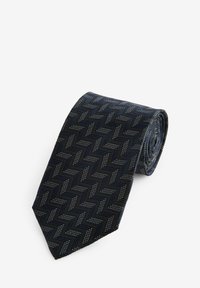 Navy tie with a herringbone pattern, featuring textured fabric and metallic accents in a zigzag design, rolled into a cylindrical shape.