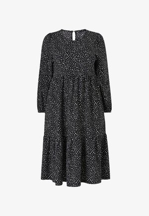 Black dress with white, speckled pattern, long sleeves, round neckline, and a keyhole detail at the back. Tiered skirt design.