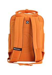 Orange fabric backpack with padded back, adjustable straps, and a top handle. Features circular stitching and a logo label on the strap.