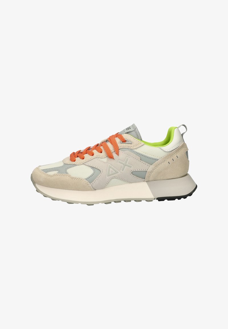 Beige and gray sneaker featuring a mix of textile and suede materials, orange laces, green accents, and a thick white sole with black outsole.