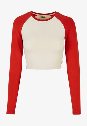 Červený dlhý rukáv crop top s bielym telom; má raglánové rukávy a okrúhly výstrih. Vyrobený z mäkkého, elastického materiálu.