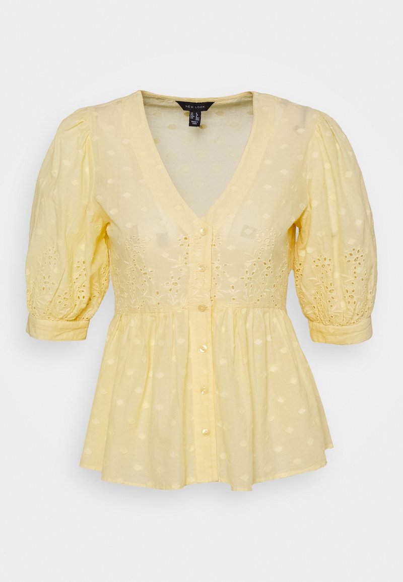 Gelbe Bluse mit V-Ausschnitt, Puffärmeln und Knopfverschluss. Hergestellt aus leichtem Stoff mit Lochstickerei und ausgestelltem Saum.