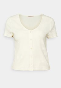 Kortärmad, ribbad tröja i blekgul med v-ringning och sexknäppning fram. Slät textur med figurnära design.