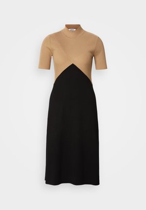 Strikket kjole med en beige ribbestrikket overdel og sort skjørt, med kortermet design og en buet sømdetalj i midjen.