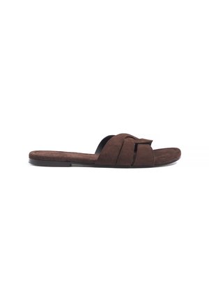 Brown suede flat slide sandal with wide woven strap and black sole, shown from side on white background.