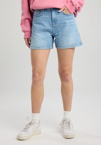 Light blue denim shorts with a high waist and frayed hem, featuring classic five-pocket styling and a slightly faded finish.