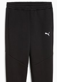Zwarte sweatpants met een getextureerd zijpaneel, elastiche tailleband en een wit Puma-logo op de linkerheup. Zacht materiaal met een getailleerd ontwerp.