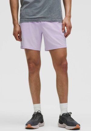 Light purple athletic shorts with a smooth texture, paired with a gray patterned short-sleeve shirt and black running shoes.