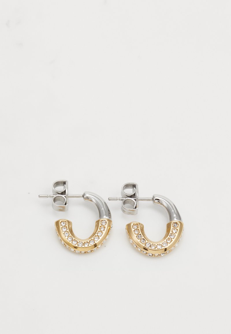Brincos em forma de argola em prata e ouro com um design em forma de U, adornados com cristais transparentes ao longo da seção dourada.