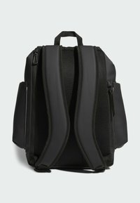 Black backpack with padded, mesh back straps, a top handle, and zippered side pockets. Features a smooth, durable material and sleek design.